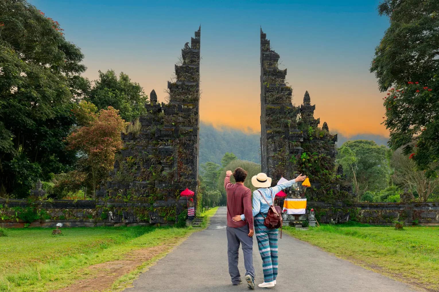 Couple walking along a quiet beach in Bali at sunset